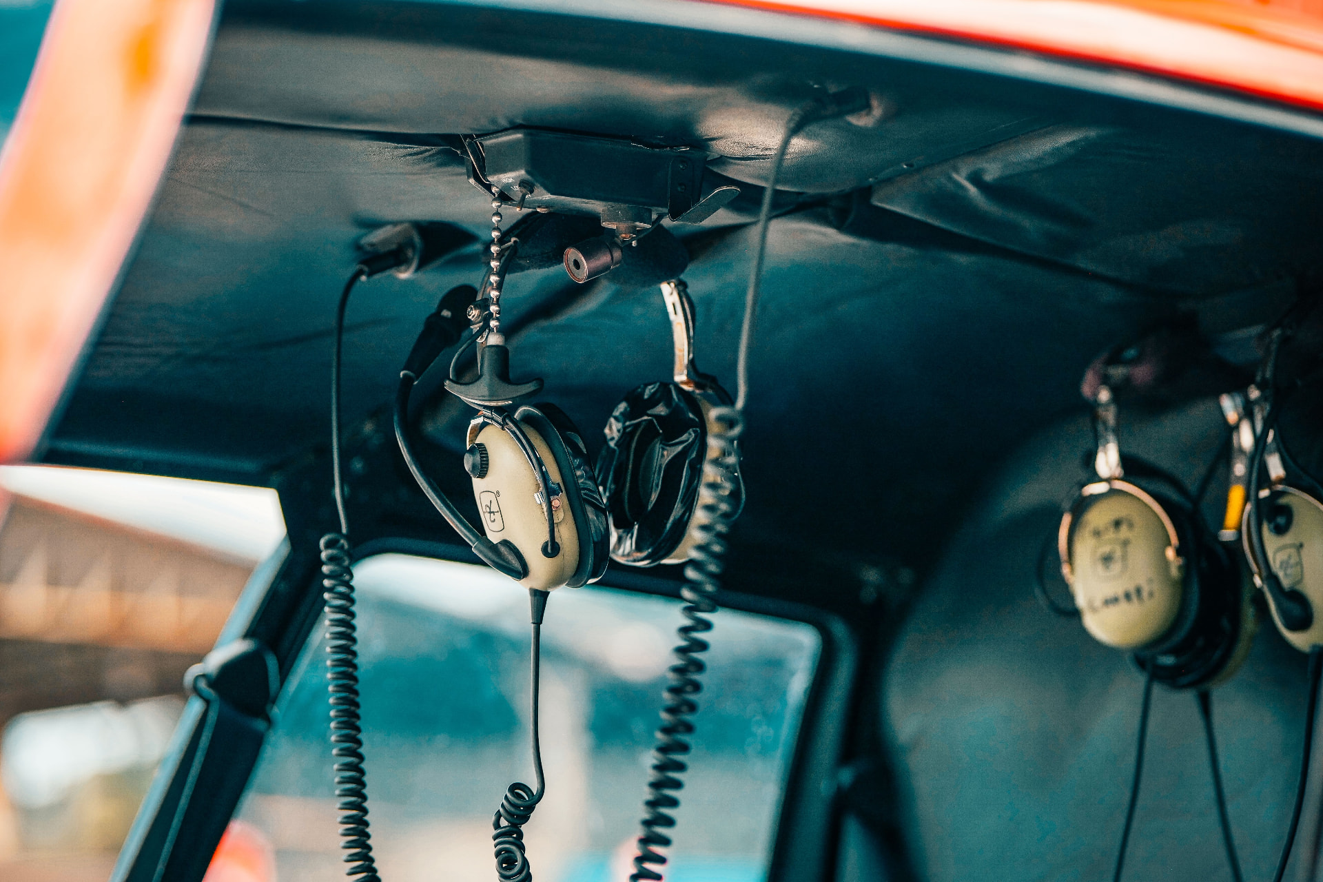 Aviation headsets hanging in a helicopter cabin