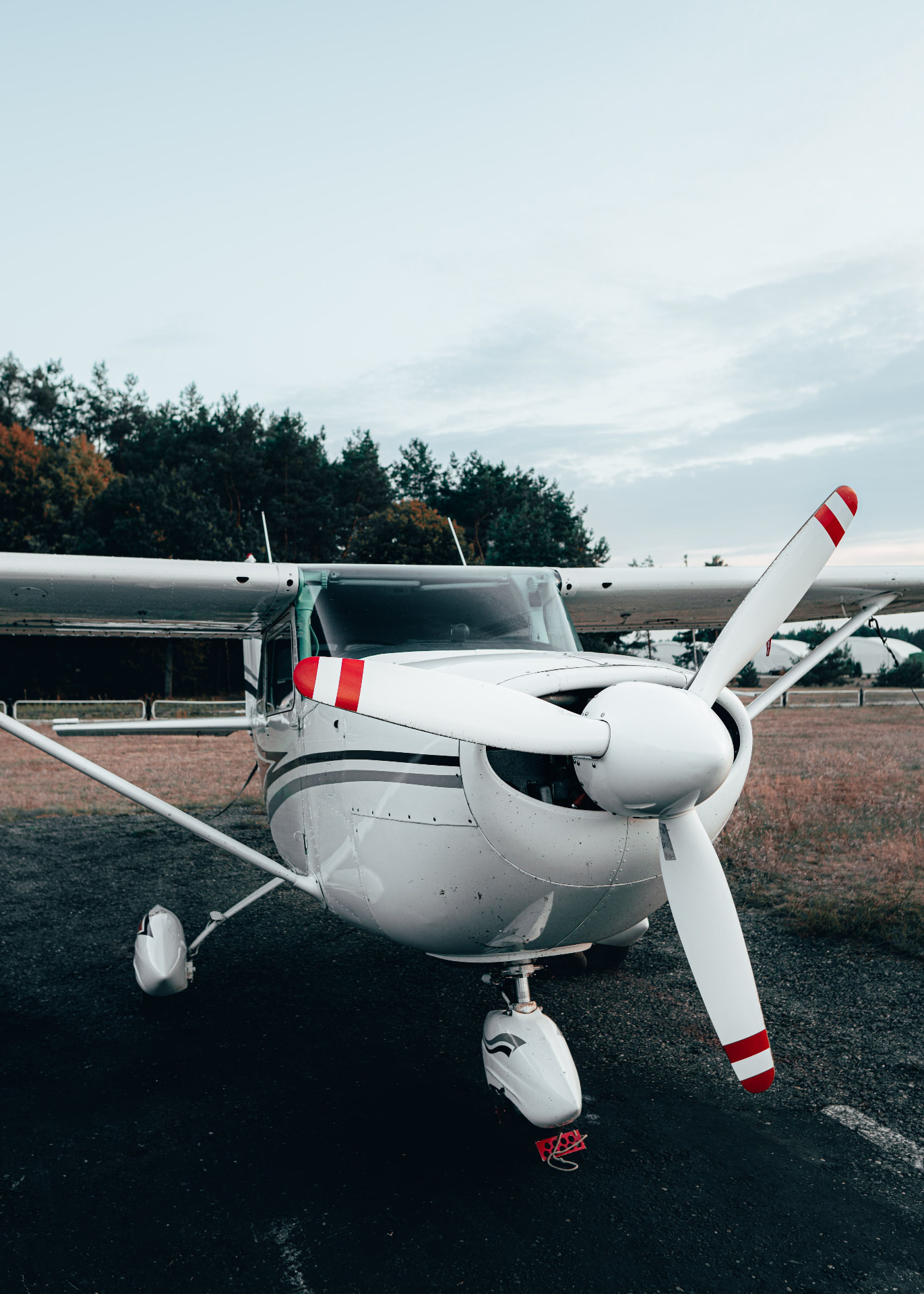Pilot seated in a light aircraft in a hangar