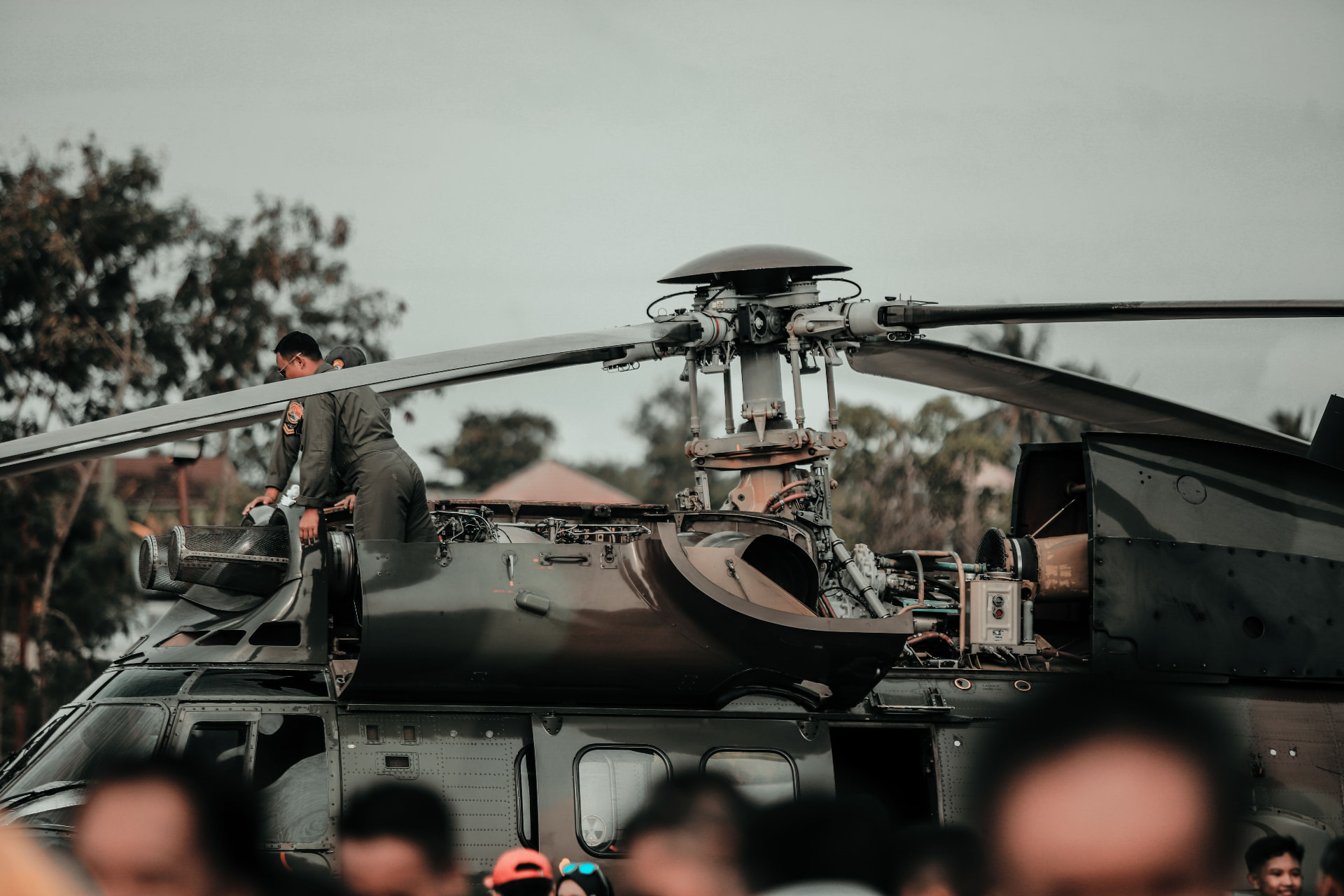 Technician working beside an exposed helicopter rotor head