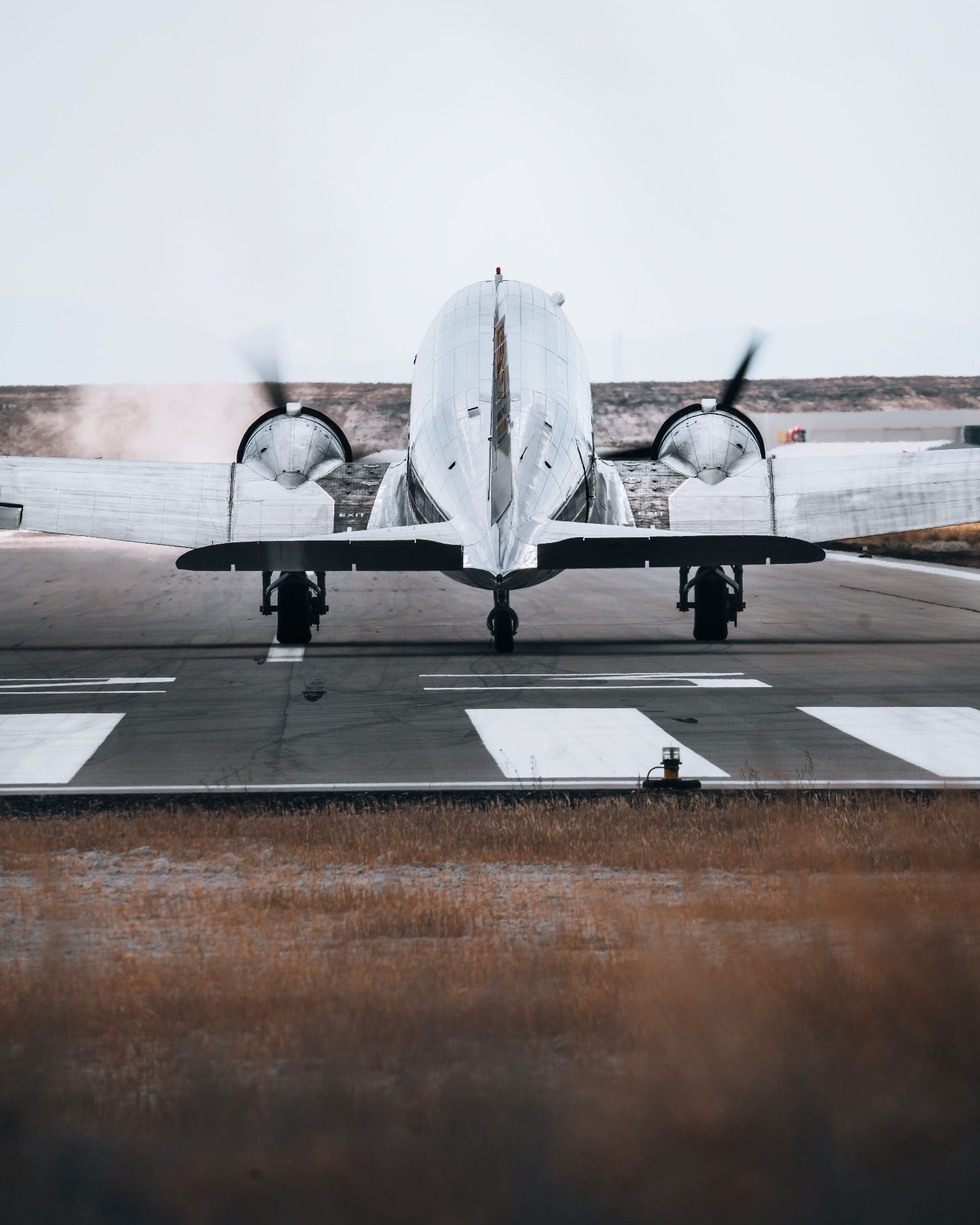 Twin-engine aircraft lined up on a runway