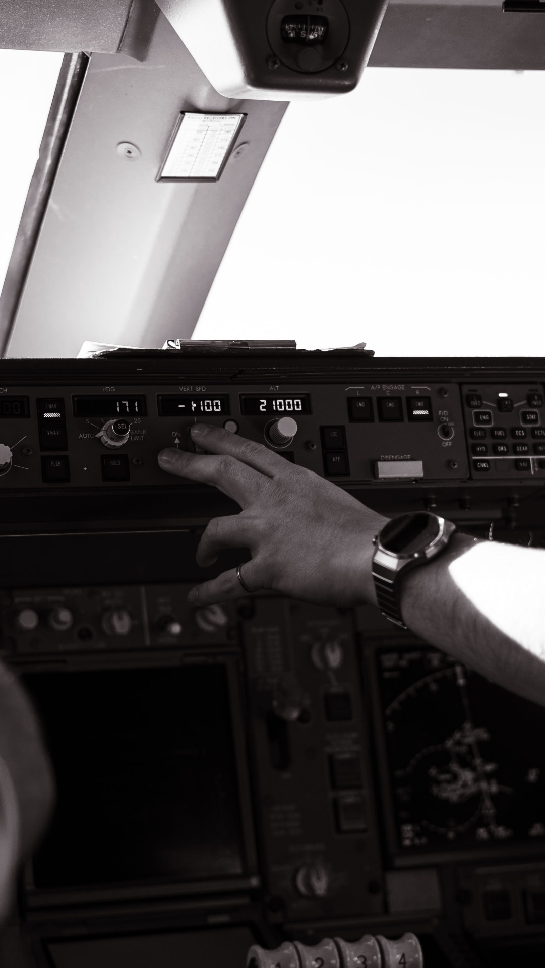 Pilot adjusting the controls in an aircraft cockpit