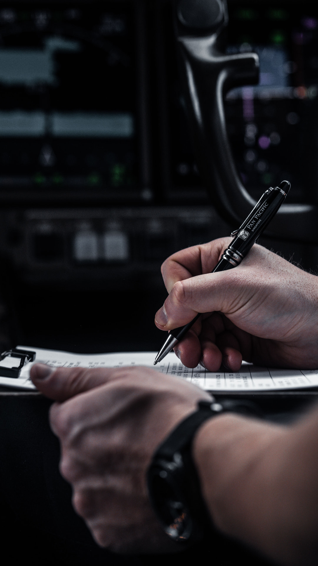 Pilot writing notes in the cockpit