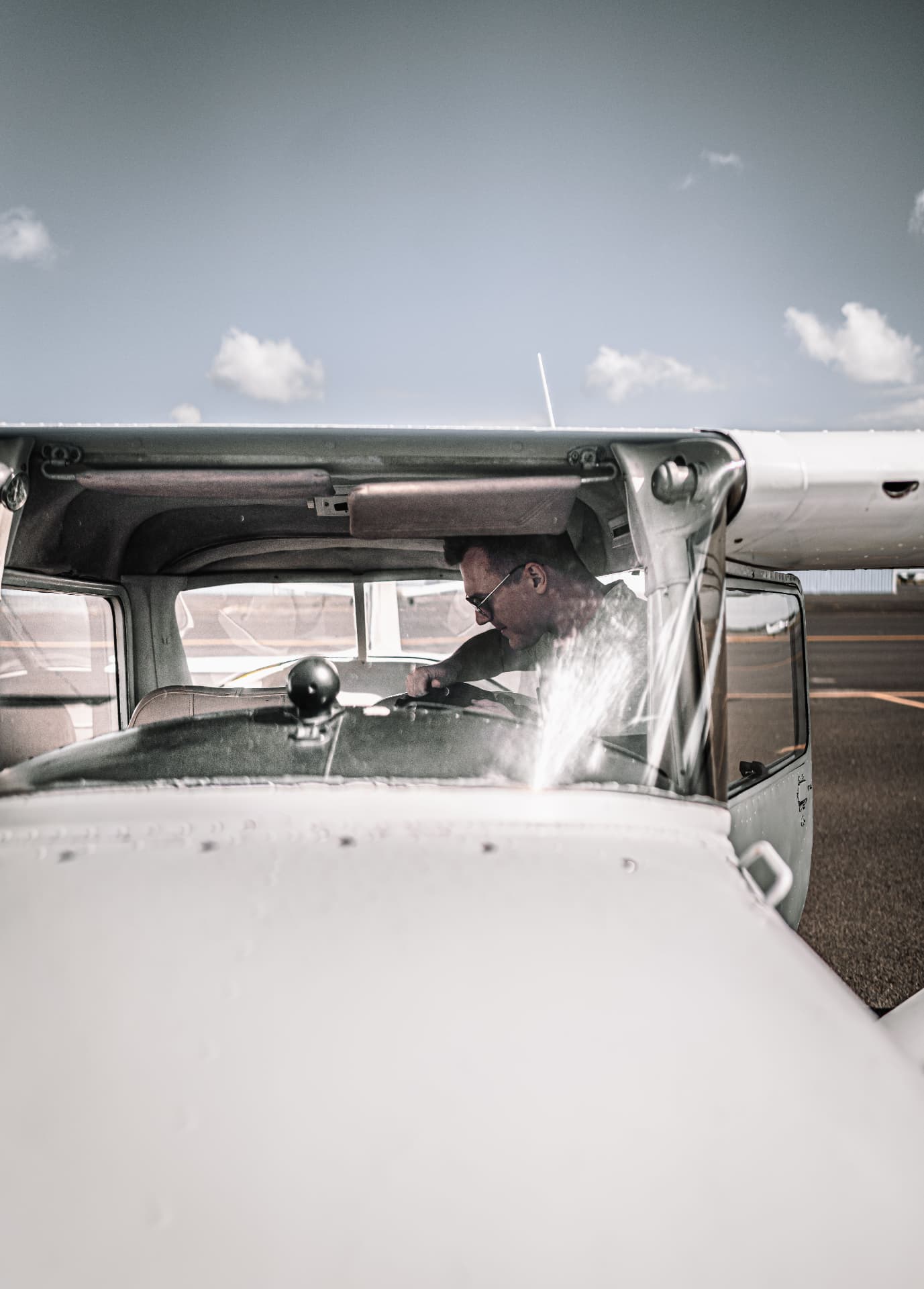 Pilot at the controls of a light aircraft on the ramp