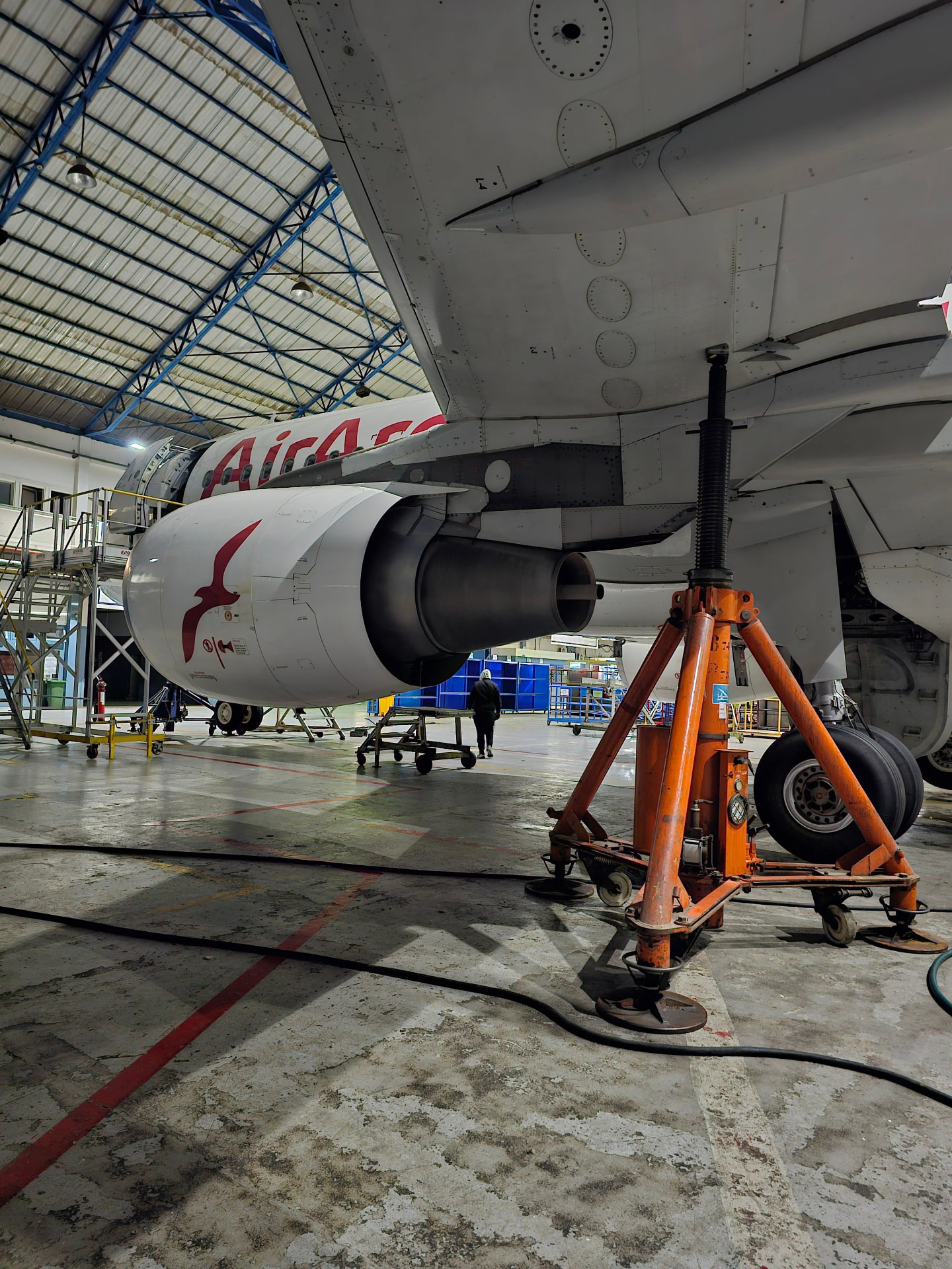 Airliner on jacks in a maintenance hangar
