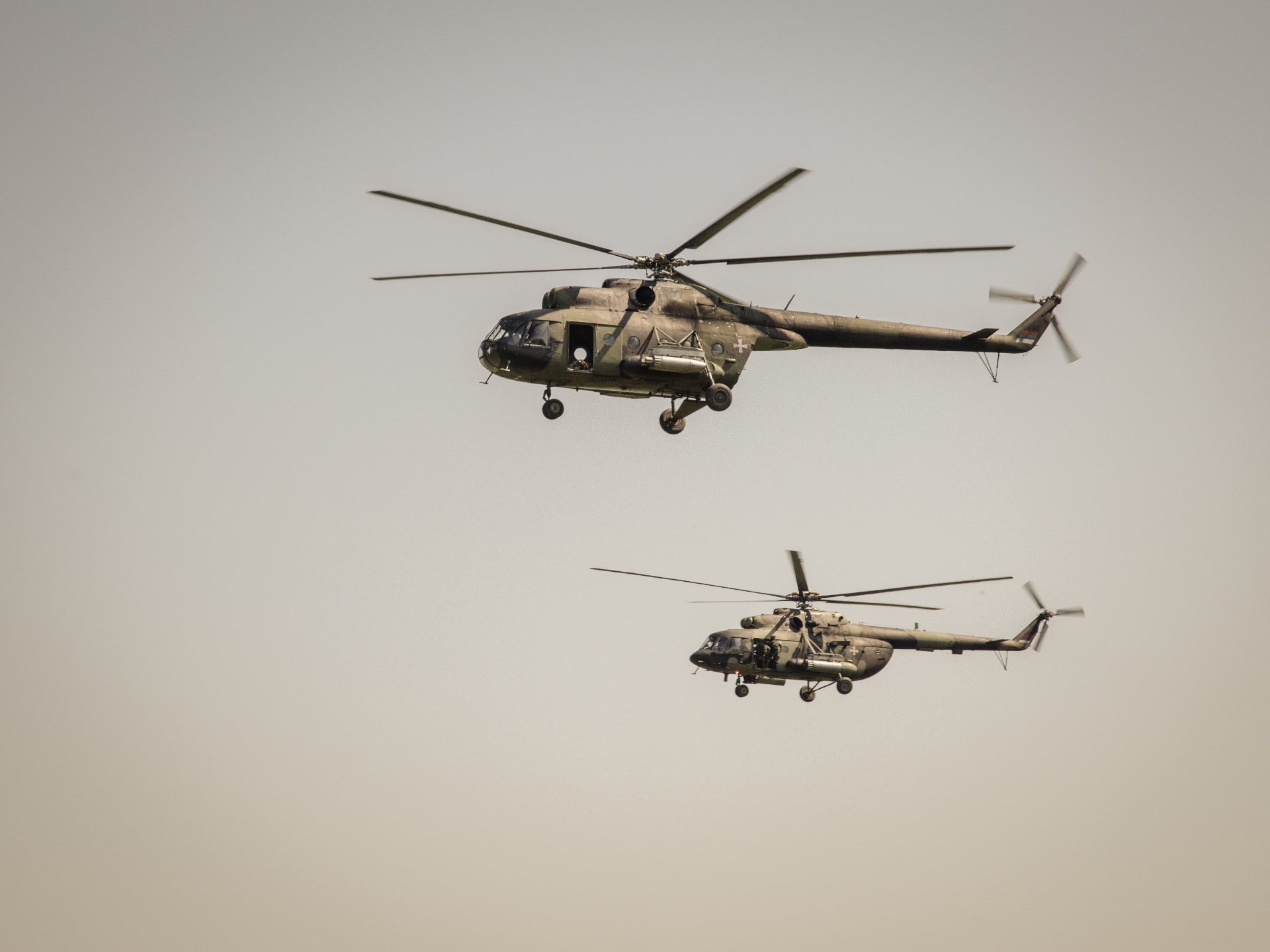 Pair of military transport helicopters in formation flight