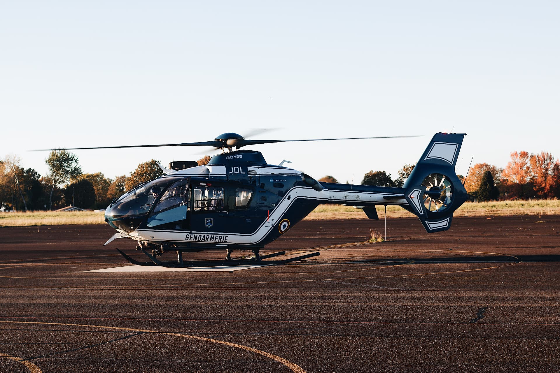 Helicopter and light aircraft side by side on an airport ramp