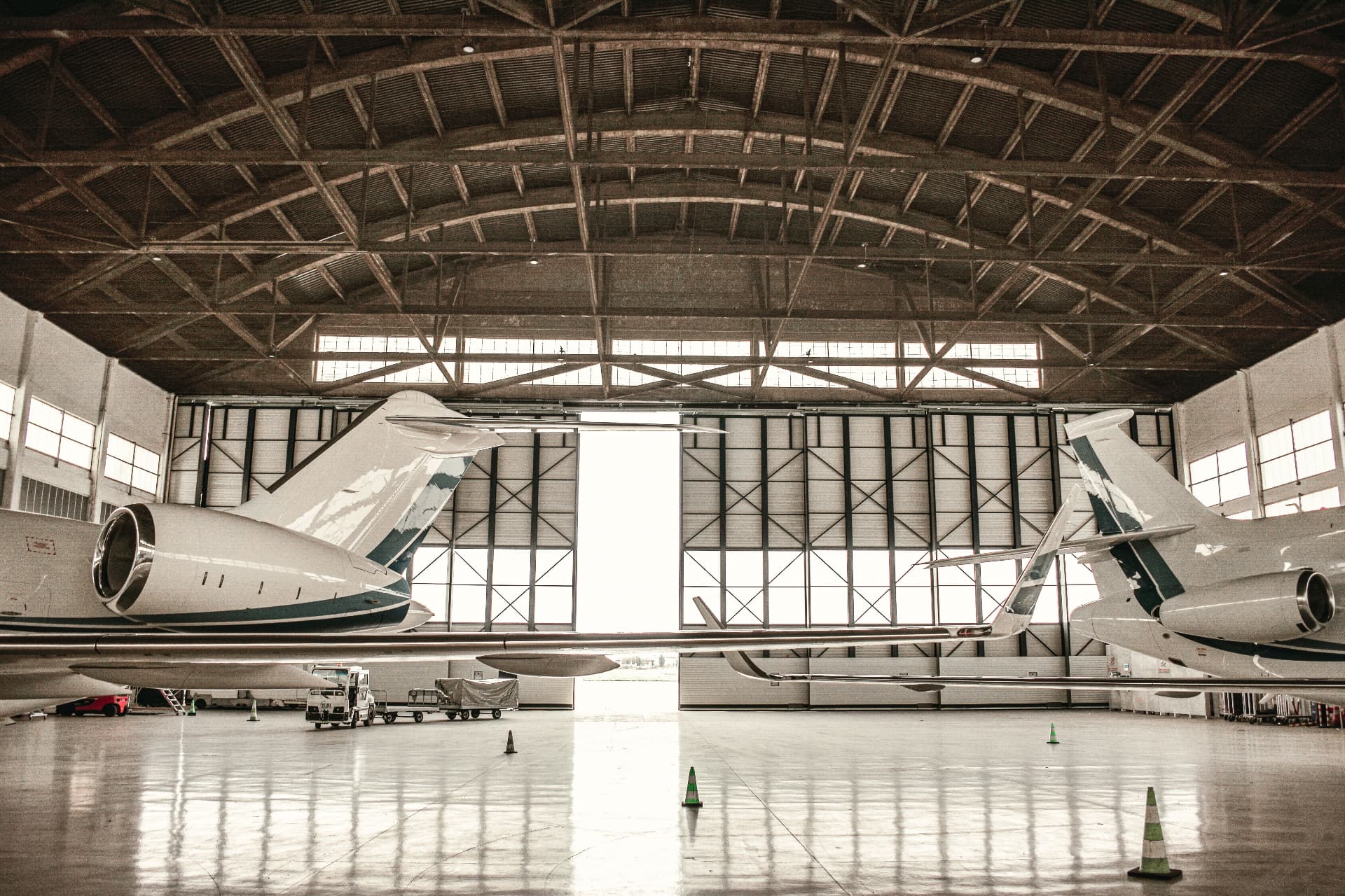 Business aircraft parked inside a large hangar